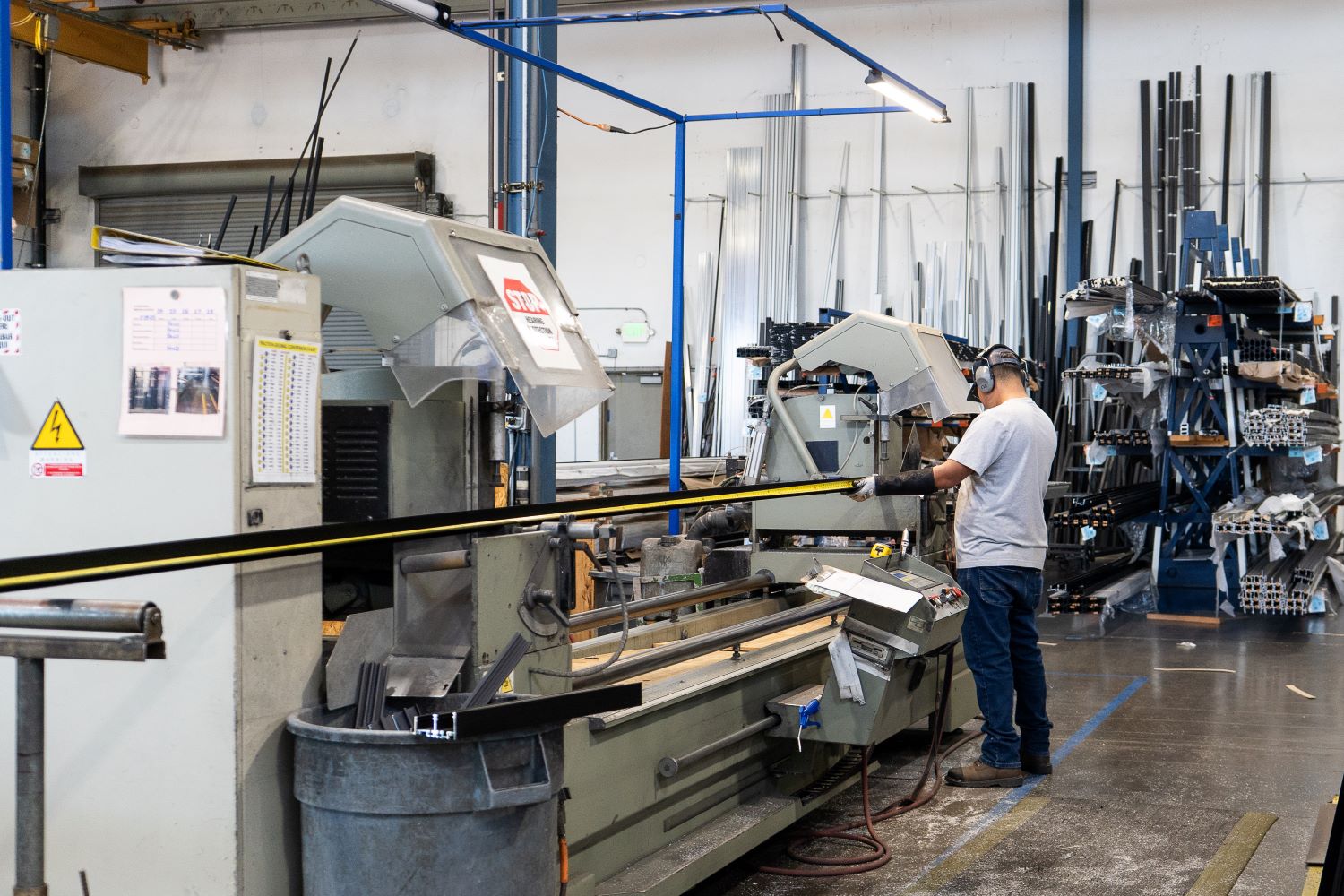 factory employee working with fenestration machinery
