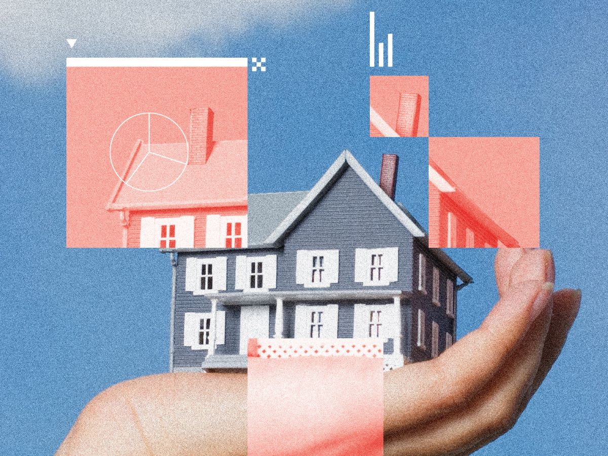 white woman's hand holding traditional two-story gray house